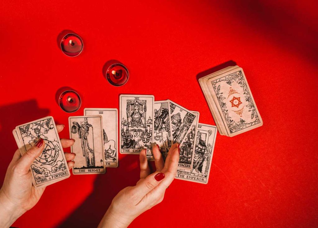 Tarot Card Reading on Red Cloth with candles